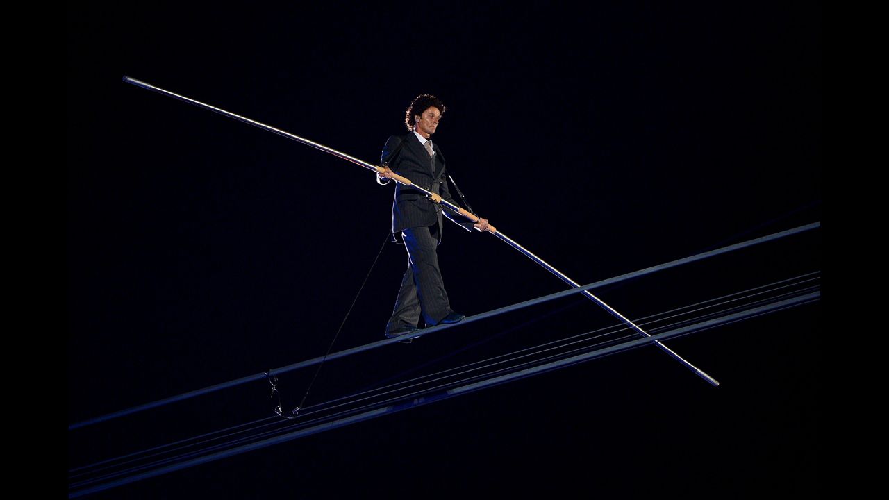 A high-wire artist performs during a rendition of Pink Floyd's "Wish You Were Here."