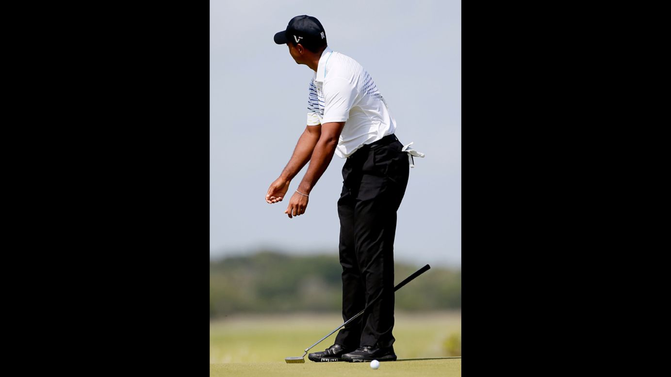 Woods, who dropped significantly in position Saturday, reacts after a missed putt on the fourth green.
