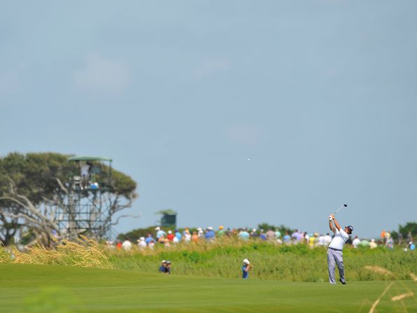 Phil Mickelson tries for the green from the fairway on the 7th hole.