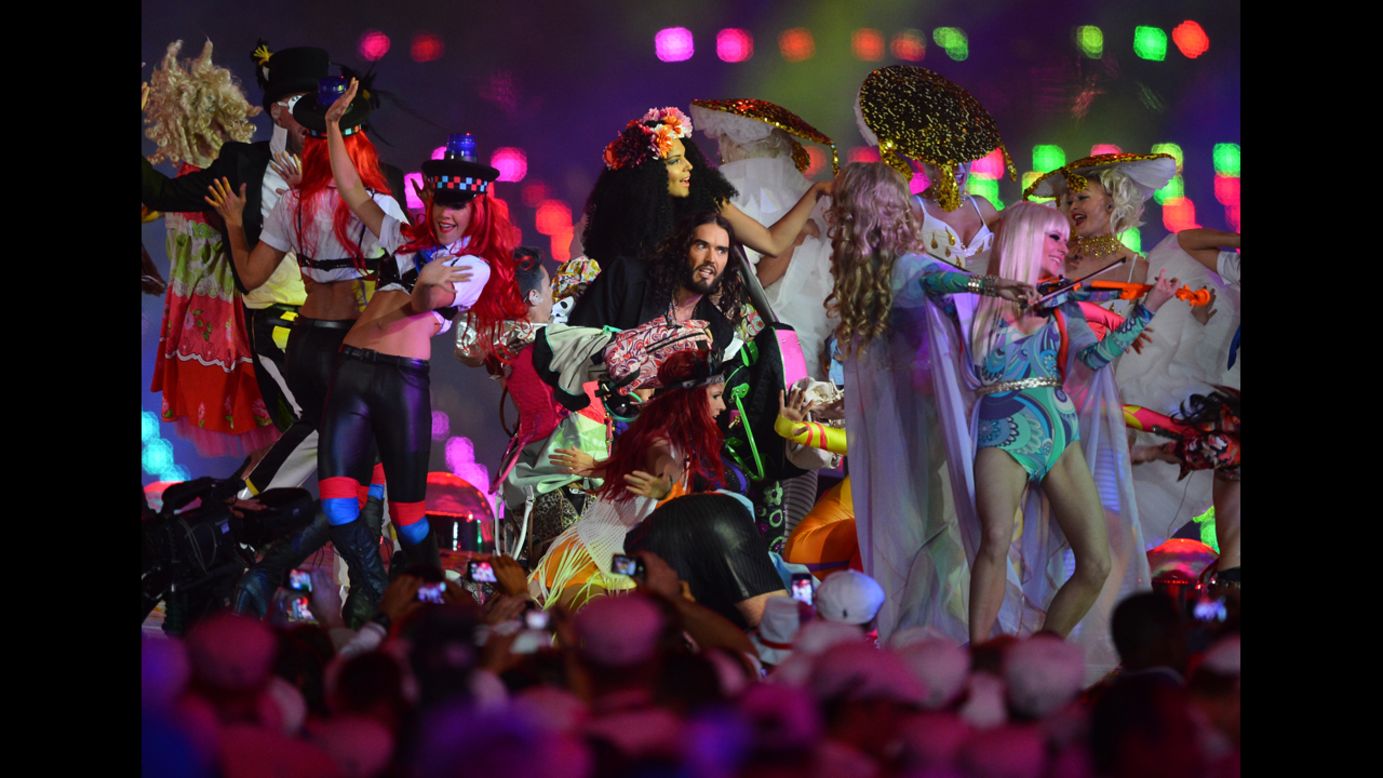 British comedian Russell Brand, center, performs at the Olympic stadium.