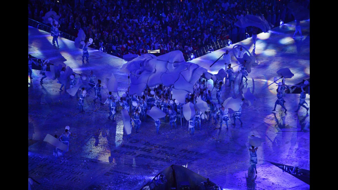 Artists form a sculpture representing the face of John Lennon during the closing ceremony.