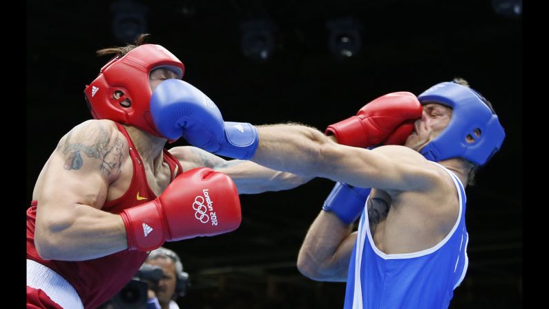 Oleksandr Usyk of the Ukraine, in red, defends against Clemente Russo of Italy, in blue, during the heavyweight boxing final. Usyk won gold on a 14-11 points decision on Day 15 of the London 2012 Olympic Games on Saturday, August 11. Check out the best images from <a href="http://www.preview.cnn.com/2012/08/10/worldsport/gallery/olympics-day-fourteen/index.html" target="_blank">Day 14 of competition</a> on Friday, August 10. The Games ran through Sunday, August 12. 