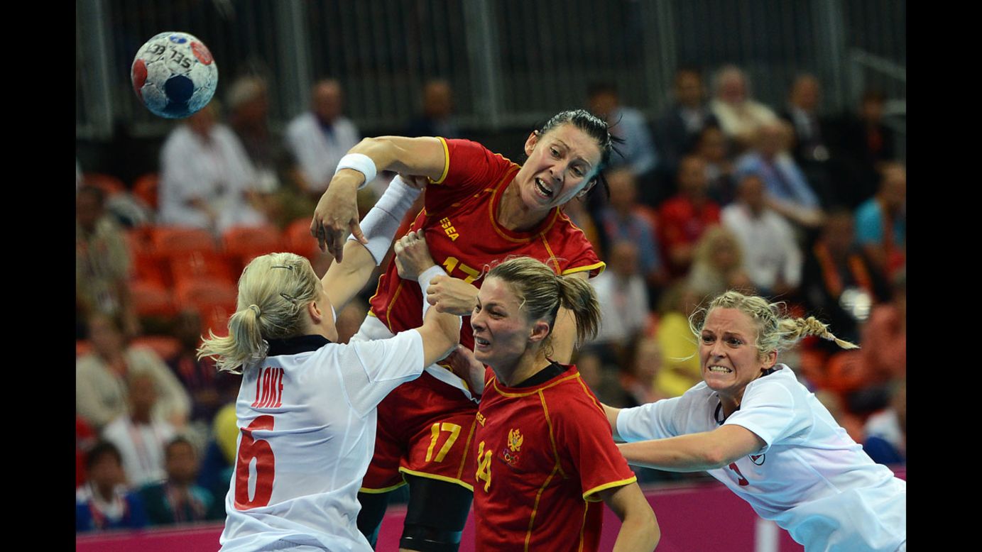 Montenegro's Bojana Popovic, top, shoots over Norway's pivot Heidi Loke, left, during the women's gold medal handball match between Norway and Montenegro.