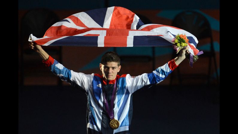 Gold medalist Luke Campbell of Great Britain celebrates with the British national flag during the awards ceremony for the Bantamweight (56kg) boxing category.