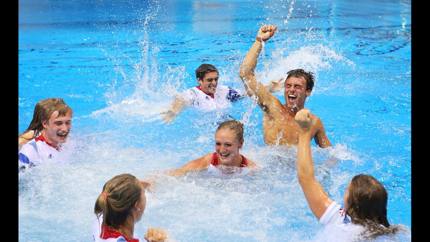 Tom Daley of Great Britain celebrates with his teammates after finishing third in the Men's 10m Platform Diving Final.