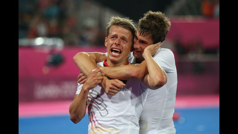 Benjamin Wess of Germany is comforted by a teammate while celebrating winning the gold medal against Netherlands in the Men's Hockey gold medal match.