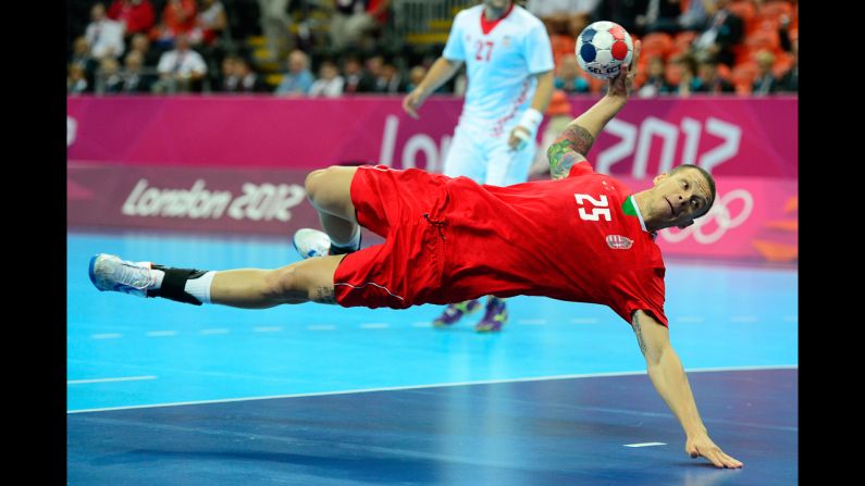 Hungary's pivot Szabolcs Zubai dives and takes a shot during the men's bronze medal handball match against Croatia.