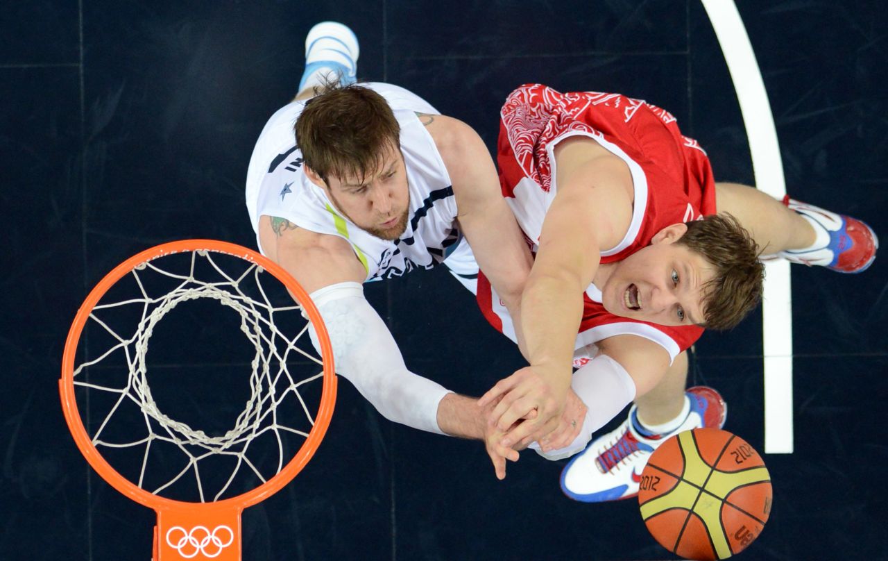 Argentinian forward Andres Nocioni, left, challenges Russian center Timofey Mozgov during the men's bronze medal basketball game at the North Greenwich Arena. Russia won 81-77.