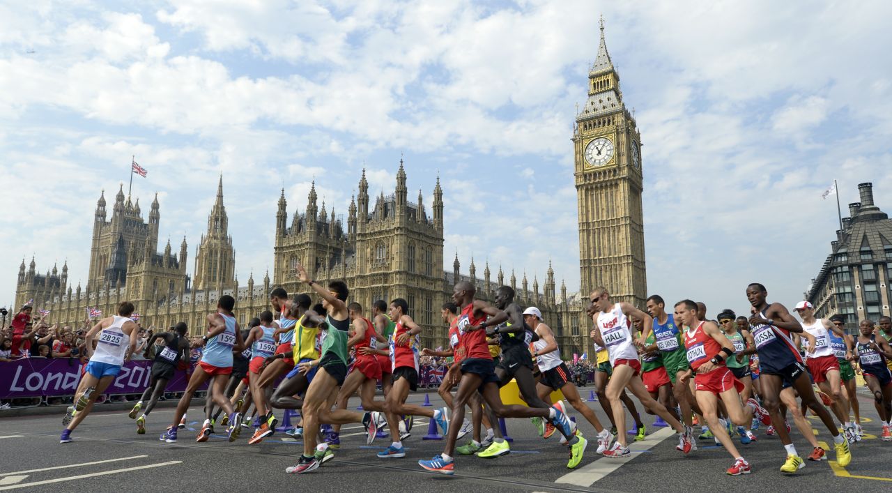 Athletes pass by Big Ben and the Palace of Westminster during the men's marathon.