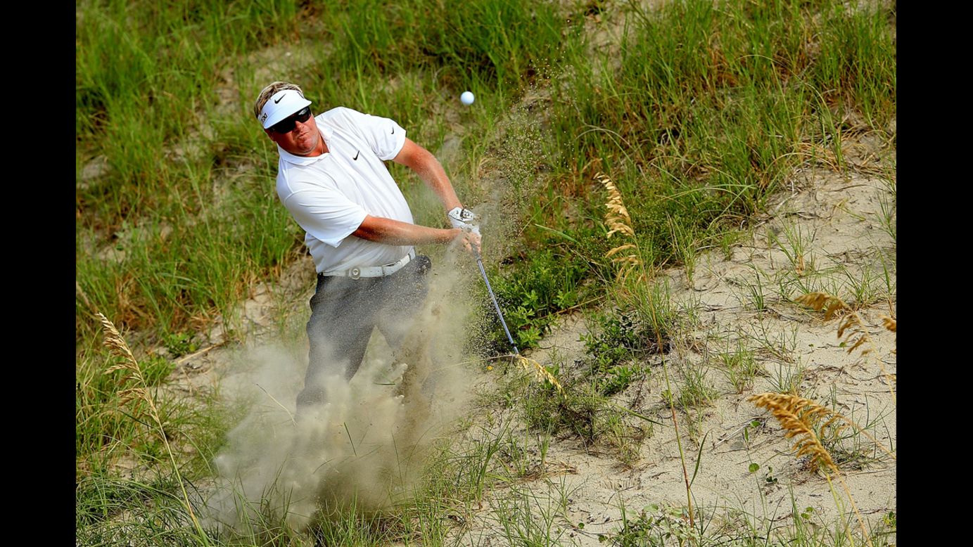 Carl Pettersson of Sweden hits out of the sand on the 10th hole.
