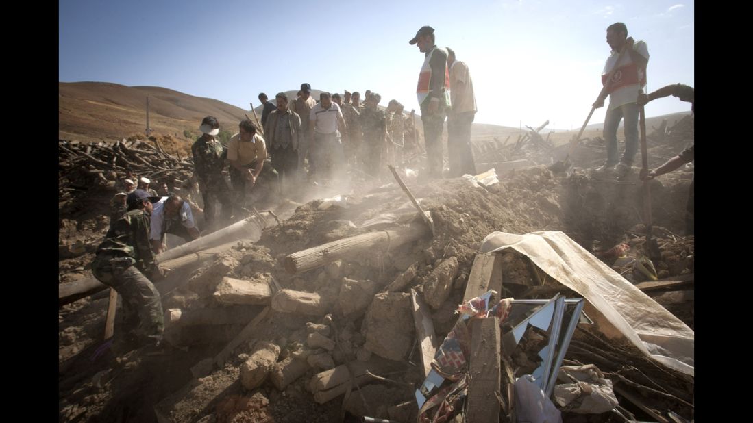 Rescuers search for survivors after an earthquake in Varzaqan, Iran, on Sunday.