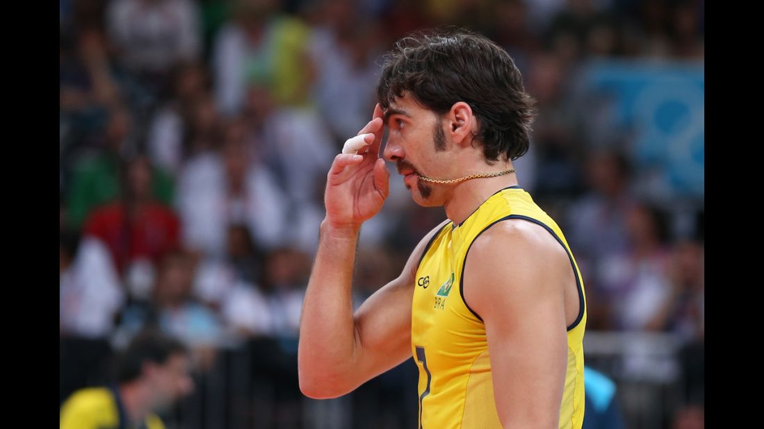 Brazil's Gilberto Godoy Filho, misunderstanding the custom of the Games, swallows his medal instead of biting down on it.