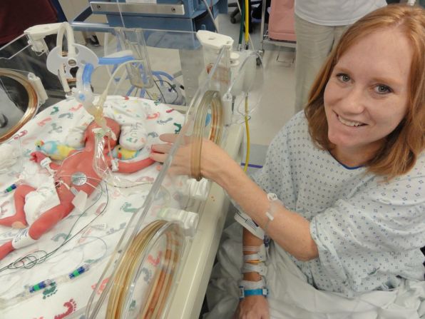 Carrie sits with one of the babies in St. Paul University Hospital's neonatal intensive care unit. 
