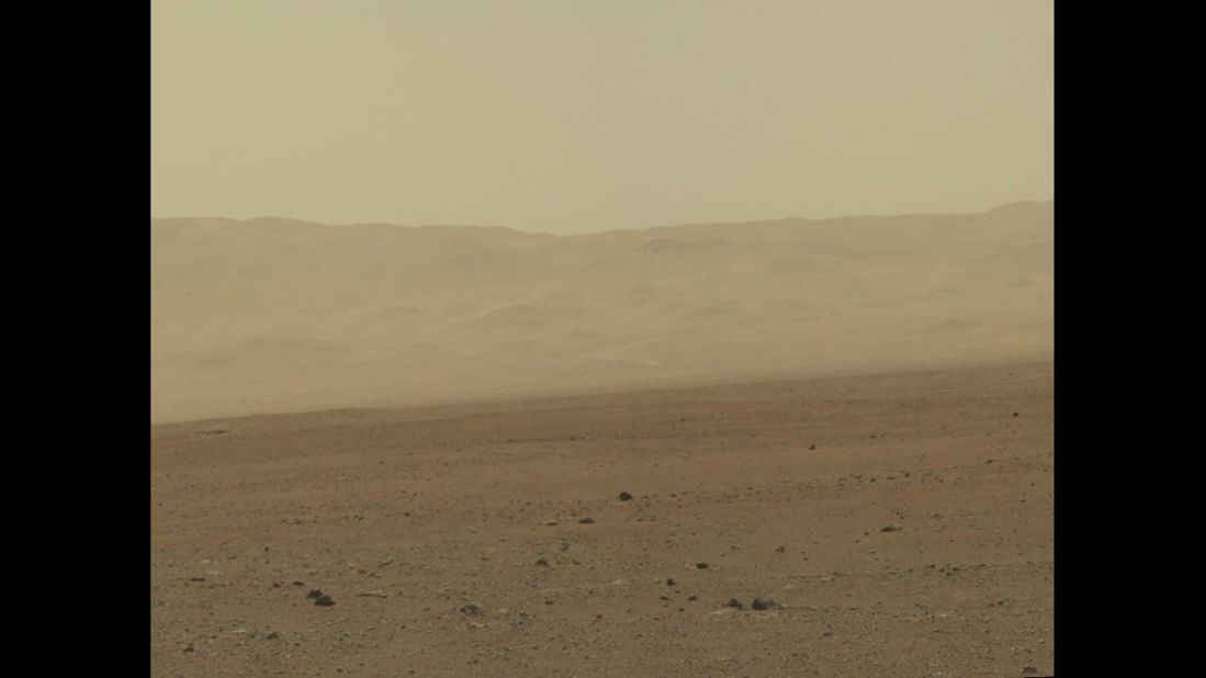 In this portion of the larger mosaic from the previous frame, the crater wall can be seen north of the landing site, or behind the rover. NASA says water erosion is believed to have created a network of valleys, which enter "Gale Crater" from the outside here.