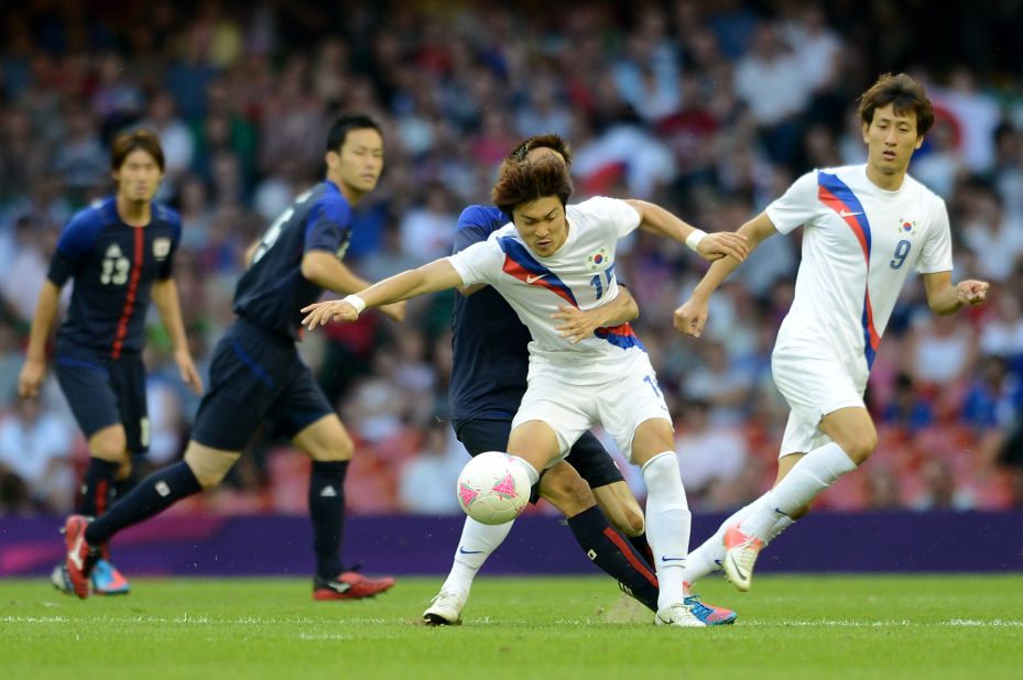 South Korean midfielder Park Jongwoo fights for the ball during the bronze medal football match the London Olympics, August 10, 2012. The IOC withheld Park's medal after he held a banner asserting South Korea's ownership of the contested islands during post-match celebrations.