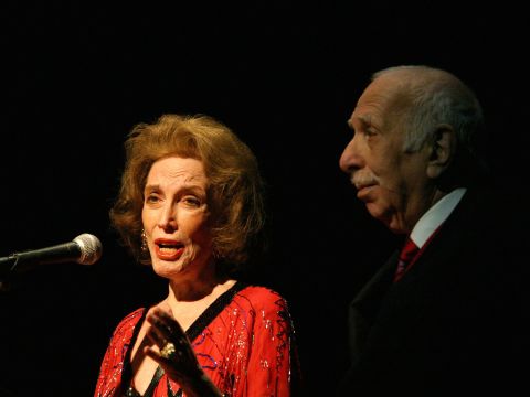 Gurley Brown speaks on stage with her husband in 2004 at the Nightlife Awards Concert in New York.