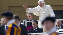 Pope Benedict XVI (R) waves as he stands in his popemobile with his butler Paolo Gabriele (C) upon arrival for a weekly general audience on April 21, 2010 at St Peter's square at The Vatican.