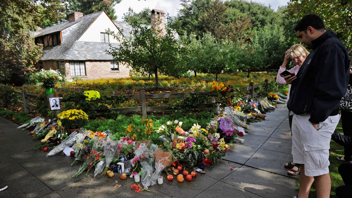 Mourners place flowers outside the Palo Alto, California, home of Apple co-founder Steve Jobs after his death last year.