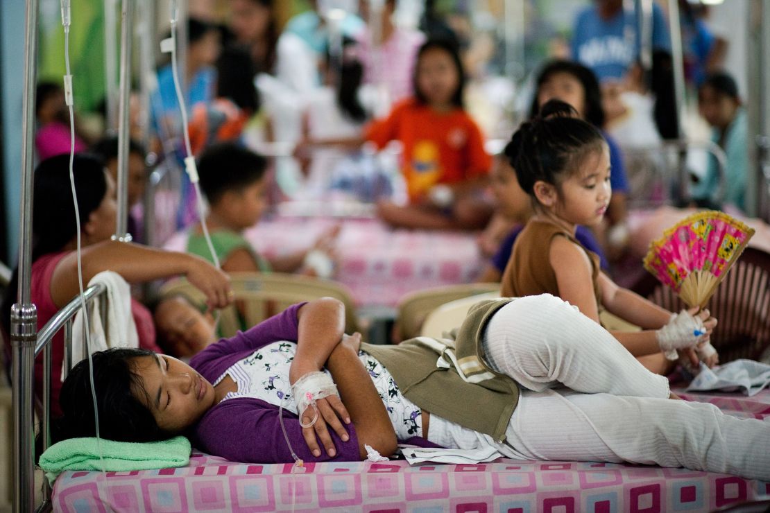 Filipinos infected with dengue  rest on beds at the Quirino hospital in Manila.