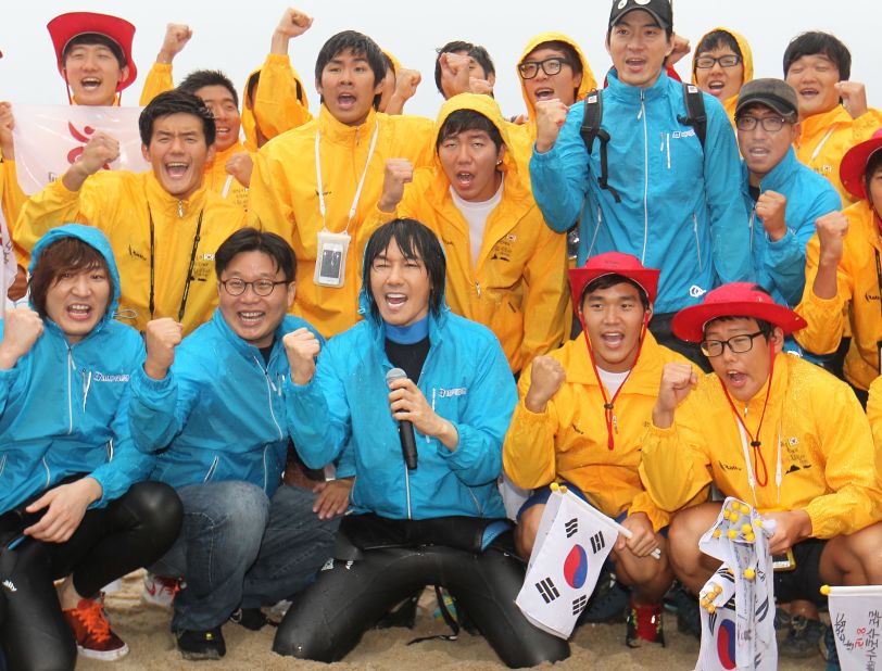 South Korean singer Kim Jang-Hoon (front) and members of a swimming club pose for a group photo before embarking on a 55-hour-long relay swim to the contested islands. They're due to arrive on Wednesday, August 15, the 67th anniversary of Korea's independence from Japanese colonial rule.