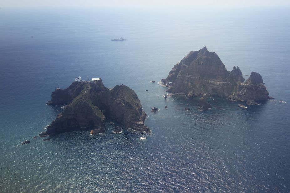 An aerial view of the remote islands disputed with Japan taken on August 10, 2012. According to a South Korean website on the islands, Dokdo has a population of three and amid the craggy rocks sit a lighthouse, lodge, helicopter landing pad, and a police station manned by South Korean officers.