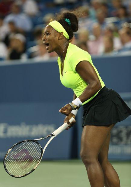 In a neon yellow outfit, Serena celebrates against Eleni Daniilidou of Greece during the 2012 Western & Southern Open in Mason, Ohio.