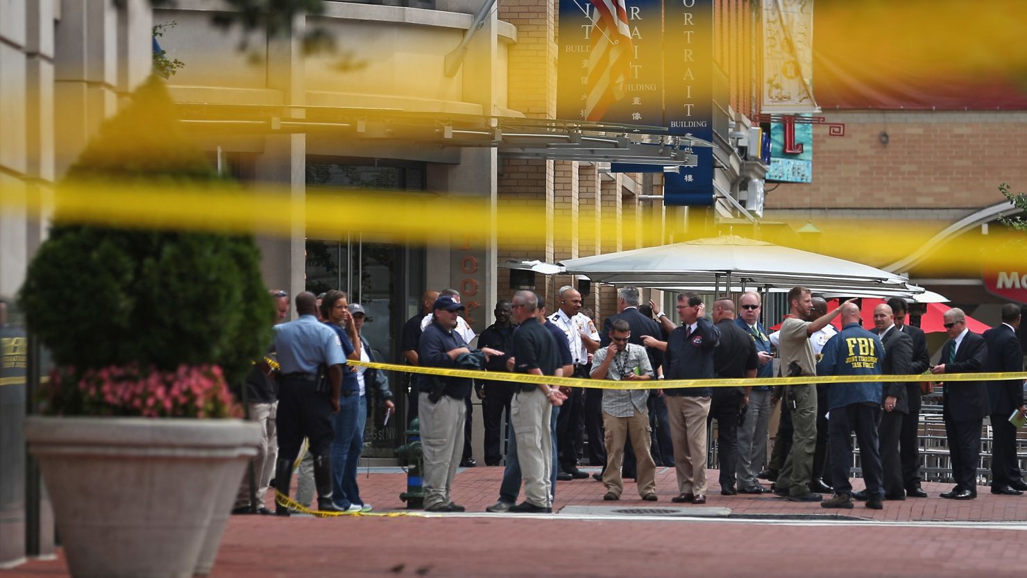 Local and federal investigators work to gather evidence after a security guard was shot in the arm at the headquarters of the Family Research Council on August 15, 2012 in Washington.