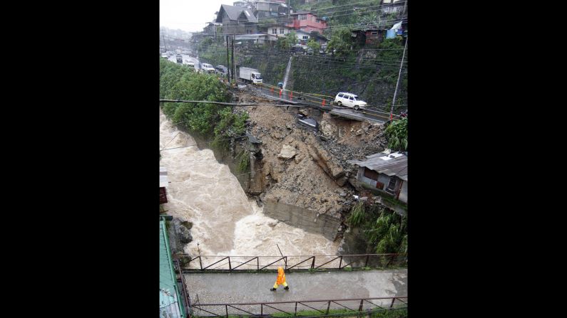 Vehicles traverse a road eroded by heavy rains along the national highway in Trinidad, Benguet province, north of Manila. Two people were killed as another tropical storm swept across the Philippines on August 15, triggering landslides in the mountainous north and dumping more heavy rain on the flood-battered capital. 