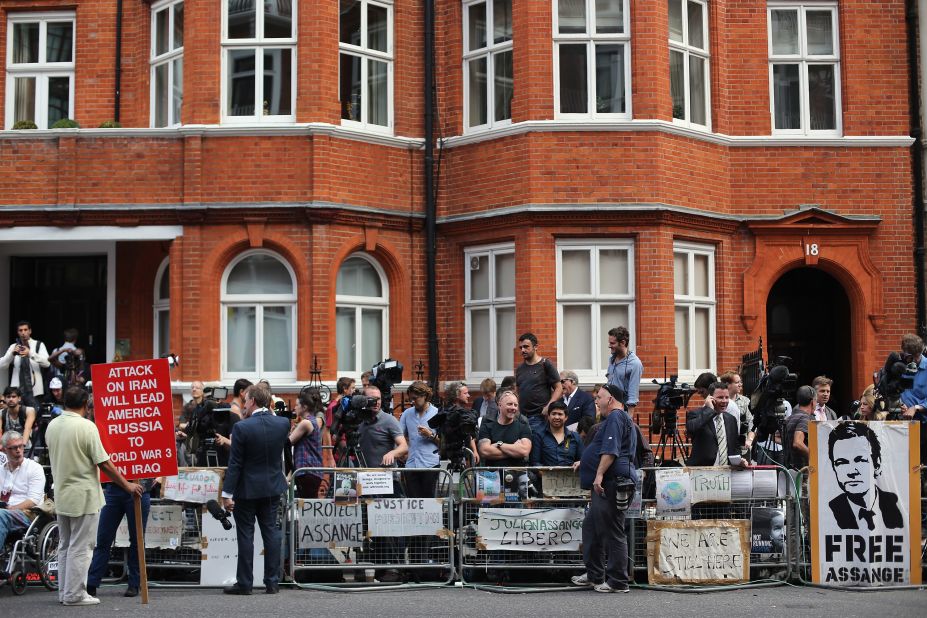 Media gather outside the Ecuadorian Embassy in London after Thursday's announcement. Meanwhile, Britain vowed to extradite the WikiLeaks founder to Sweden to face questioning on sex crime charges.