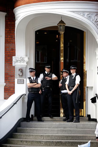 Police stand guard outside the entrance. The British government insists the UK still has a legal obligation to extradite Assange to Sweden.