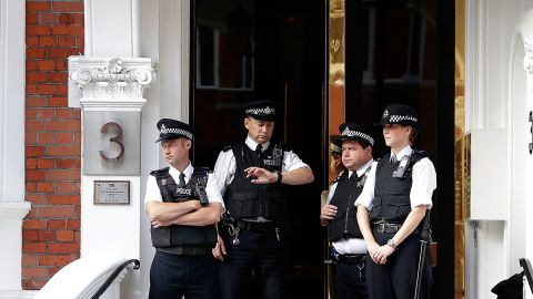 Police stand guard outside the embassy. Britain says it has a legal obligation to extradite Julian Assange.
