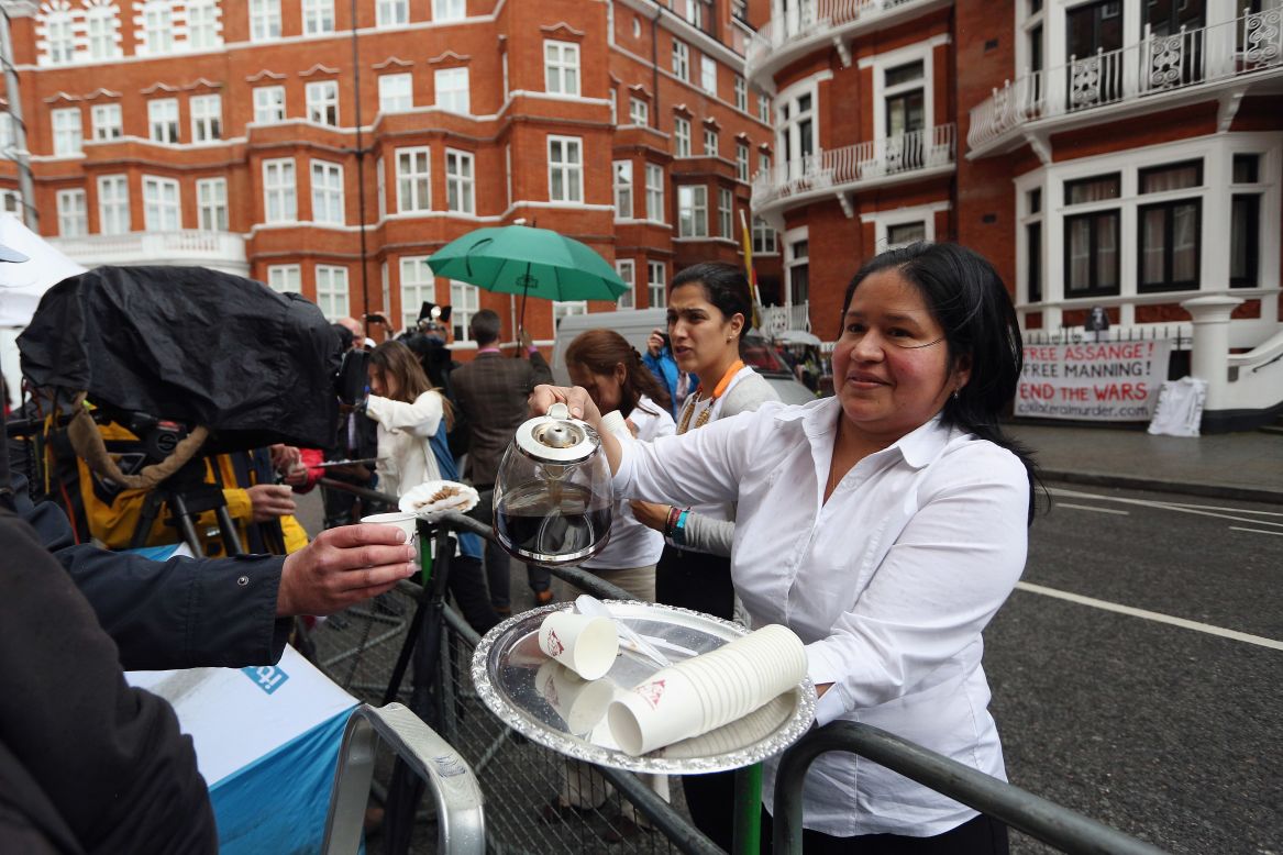 Embassy staff serve coffee to the media waiting outside the building for a glimpse of Assange.