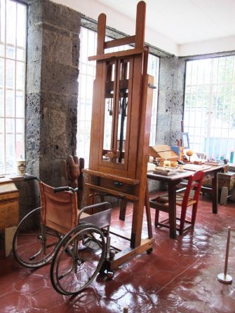In her studio at Casa Azul, Frida Kahlo's wheelchair is positioned in front of an easel purportedly given to her by Nelson Rockefeller. 