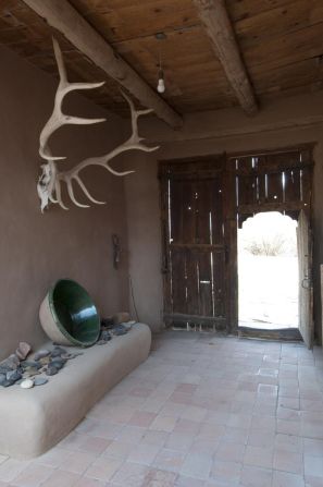 The wooden door to Georgia O'Keeffe's house in Abiquiu, New Mexico, opens into this adobe zaguan (vestibule).   