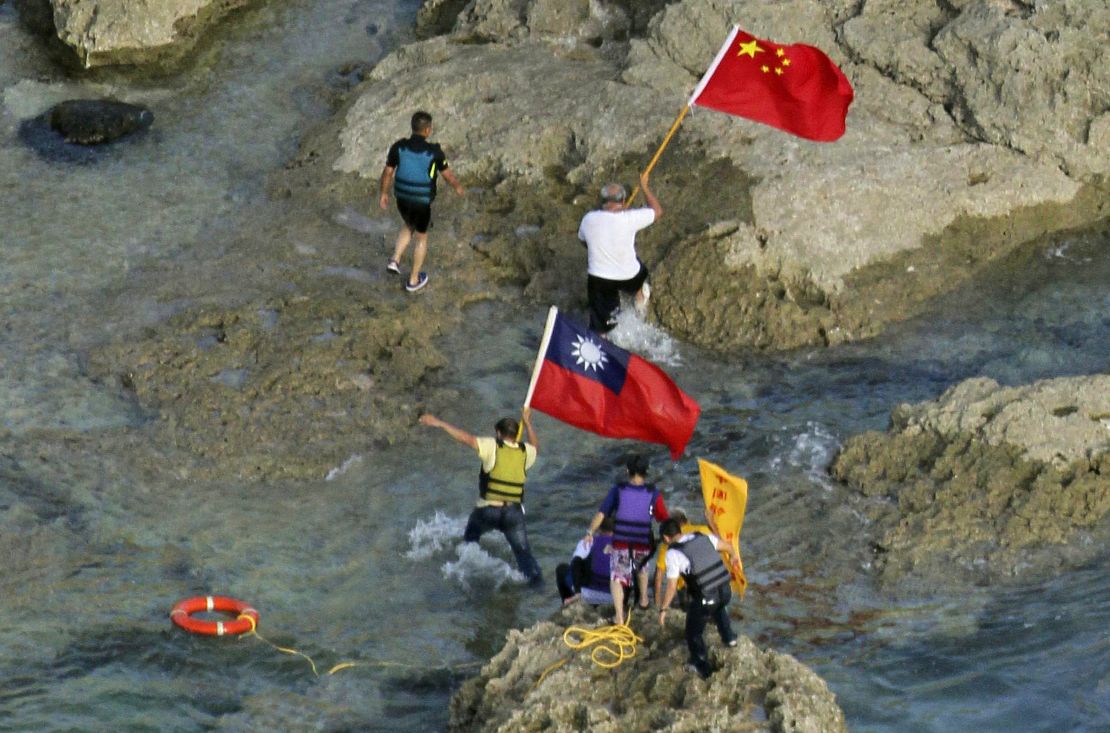 Activists carry Chinese and Taiwanese flags on the disputed island on Wednesday.