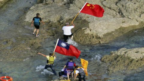 Activists carry Chinese and Taiwan flags on the disputed island known as Senkaku in Japan and Diaoyu in China Wednesday.