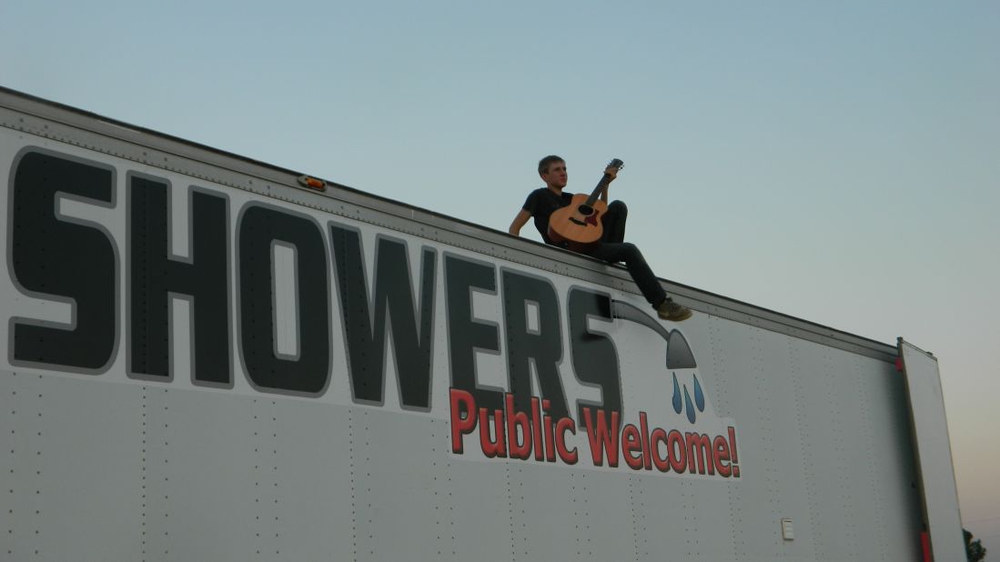 Evan Jensen, 18, rests atop his shower truck, which he helped build along with his family after noticing there was no place to get a decent shower in the oil boomtown of Williston, North Dakota.   