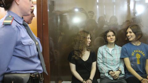 Members of the all-girl punk band 'Pussy Riot'  sit in a glass-walled cage after being sentenced in Moscow on Friday.