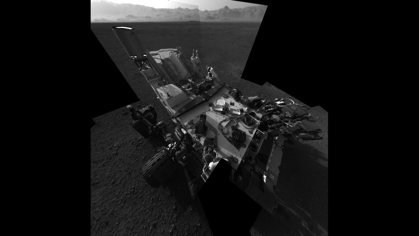 An updated self-portrait of the Mars rover Curiosity, showing more of the rover's deck. This image is a mosiac compiled from images taken from the navigation camera. The wall of "Gale Crater," the rover's landing site, can be seen at the top of the image.