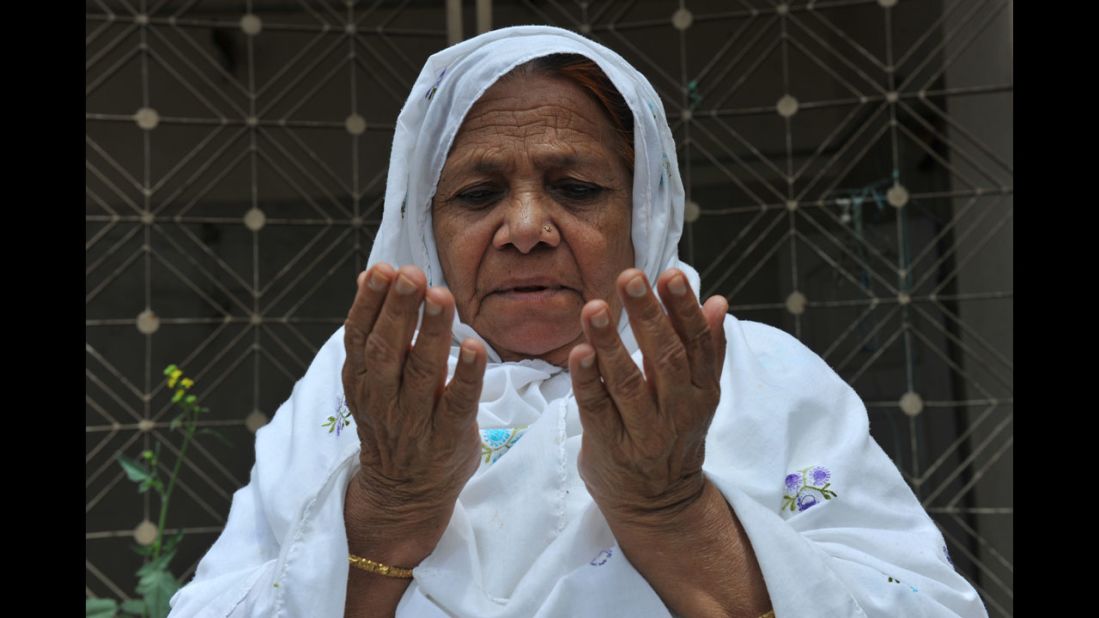 An Indian Muslim woman prays  outside the historic Mecca Masjid in Hyderabad.