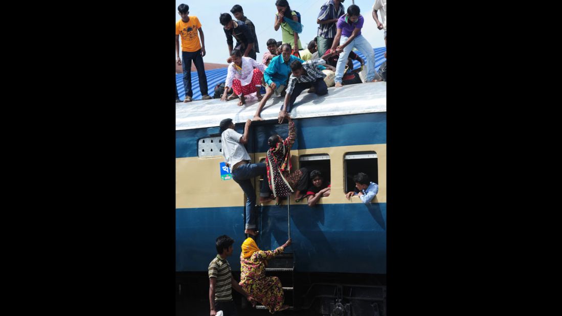 People cram onto a train as they rush home to be with their families in remote villages for Eid al-Fitr, in Dhaka, Bangladesh. 