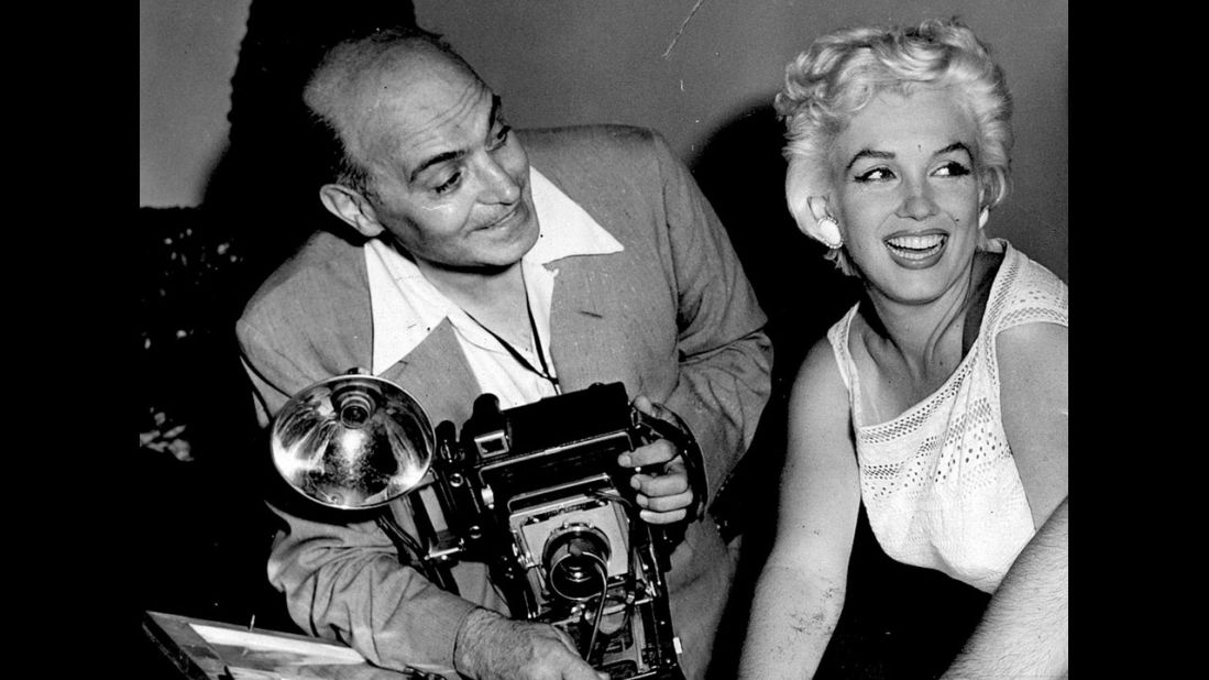 Mike Rotunno was a newspaper photographer who started a business at Midway Airport in 1930s Chicago shooting pictures for travelers who wanted a memento as they passed through.  Many celebrities were among them. Here, Rotunno poses with Marilyn Monroe in 1955.
