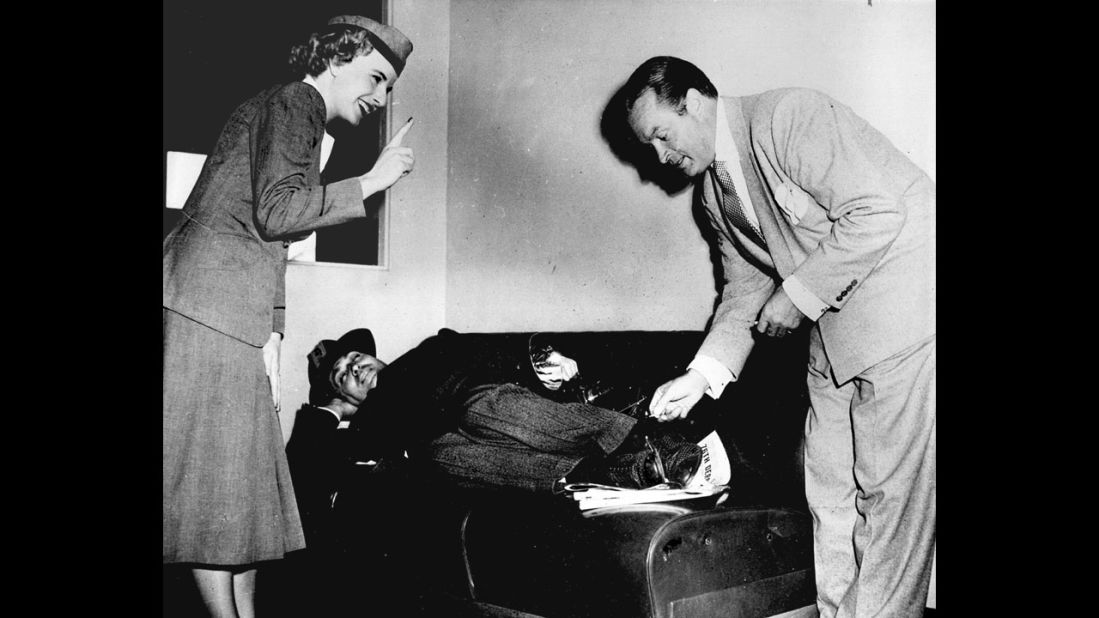 Bob Hope pretends to give Rotunno a "hotfoot" as a stewardess admonishes him in the 1940s.