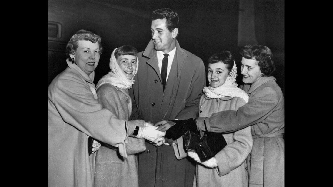 Rock Hudson cuddles with fans at Midway airport.