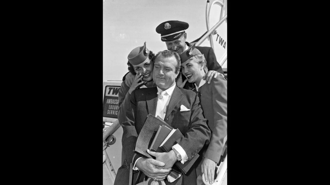 Comic Red Skelton poses with TWA flight crew and pilot in the 1950s.