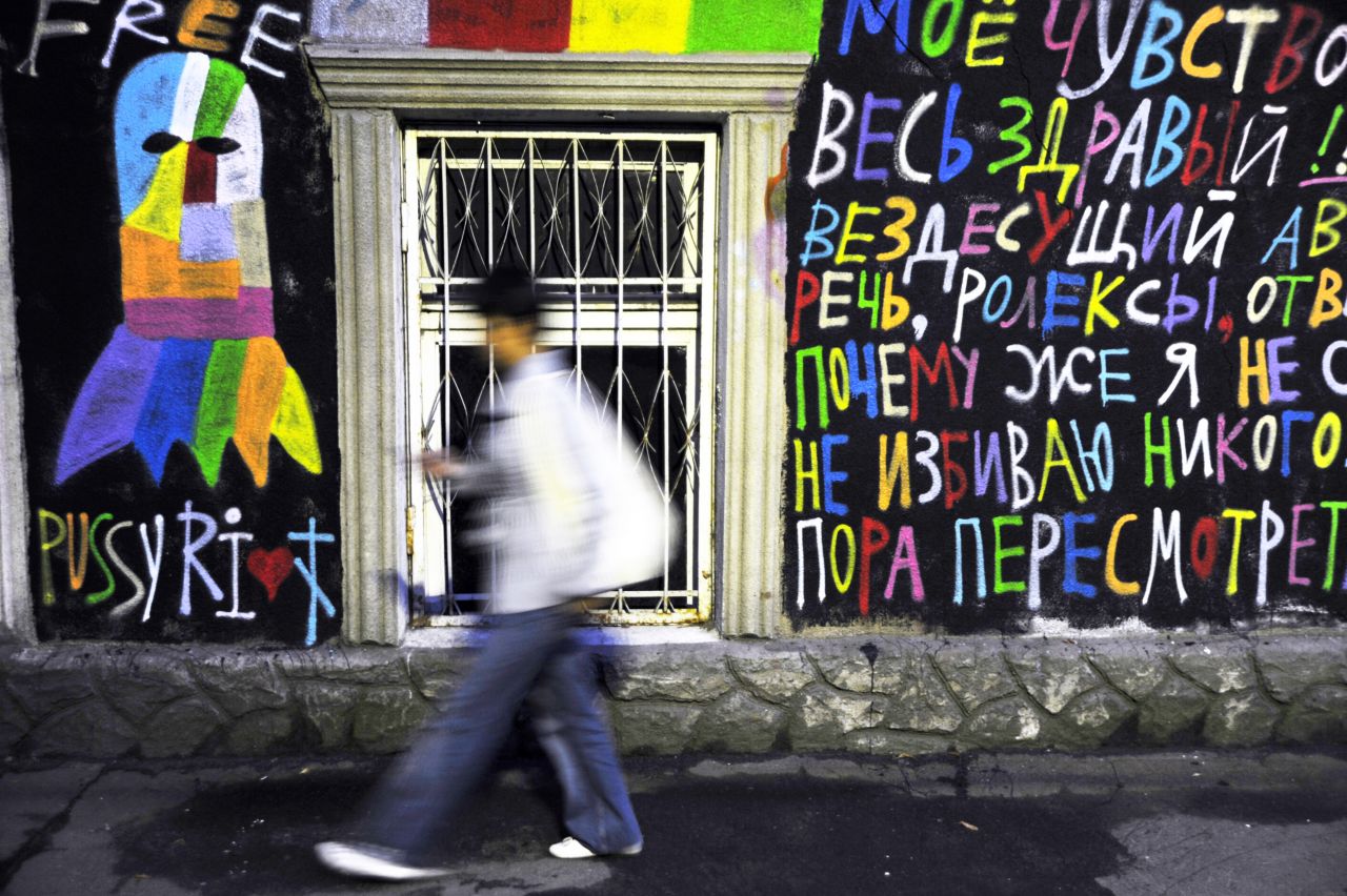 A man walks past pro-Pussy Riot graffiti in Moscow. Band members were charged after screaming "Mother Mary please drive Putin away" during a concert inside Christ Savior Cathedral, in February. 