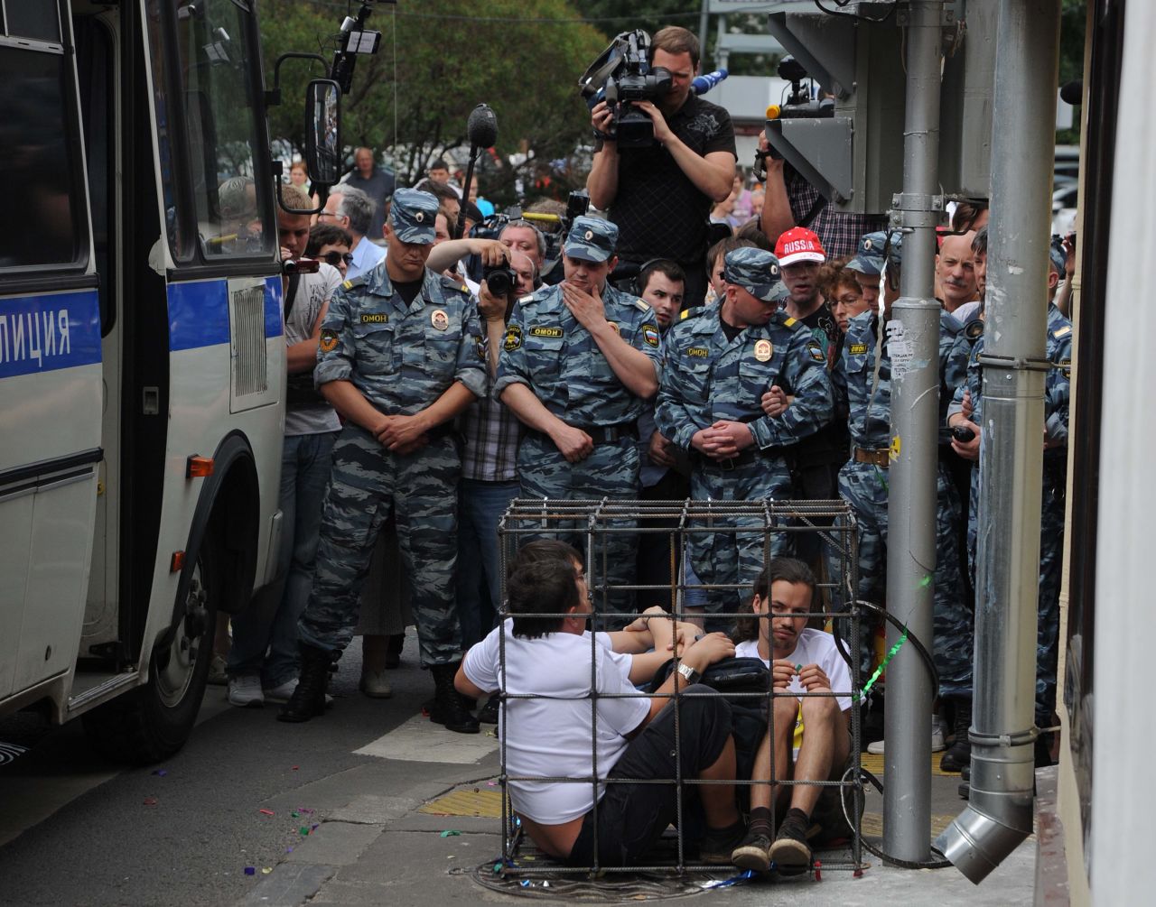Supporters sit locked in a mock defendants cage outside a Moscow court. The band members have been charged with hooliganism aimed at "inciting religious hatred."