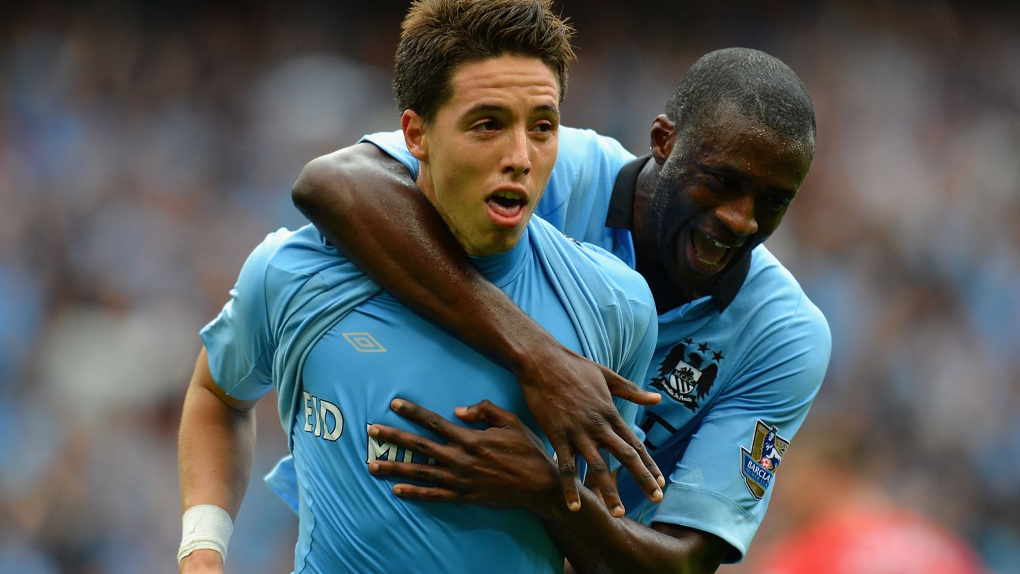 Samir Nasri is congratulated by Yaya Toure after scoring the winning goal for Manchester City at the Etihad Stadium.