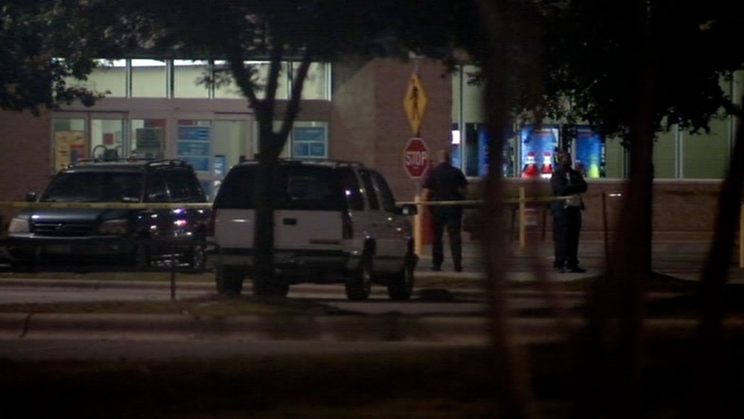 Police investigate the scene of a shooting on Sunday at a parking lot in Cedar Park, Texas.
