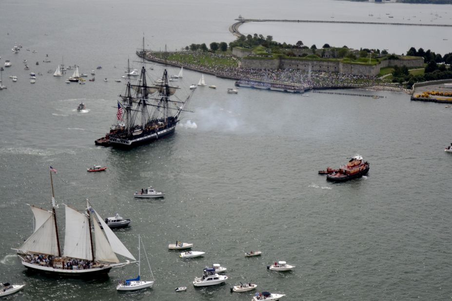 The USS Constitution fires a 21-gun saulte toward Fort Independence on Castle Island.